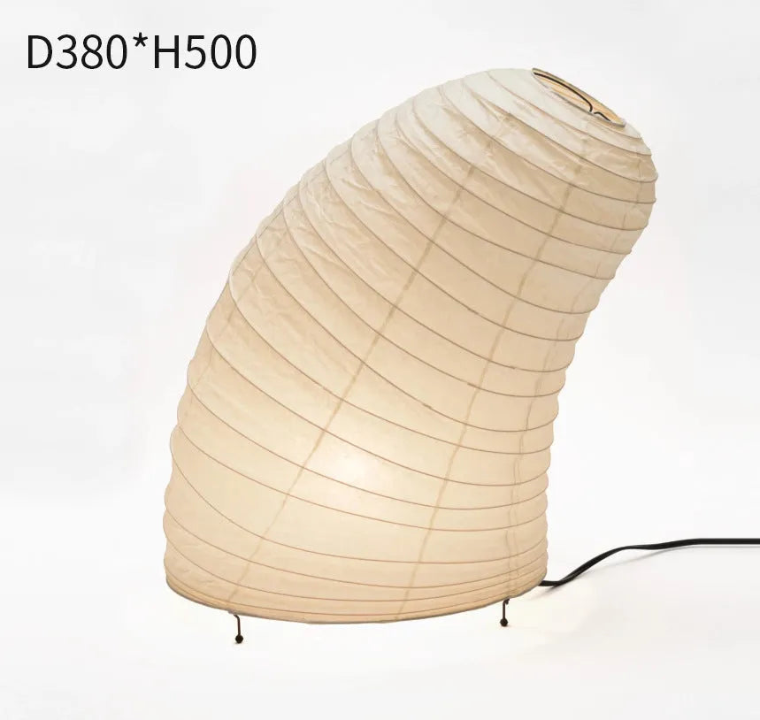 Japanese style rice paper table lamp with aluminium body and decorative shade on wooden surface