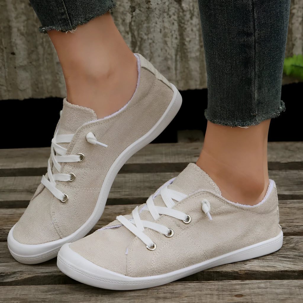 Women's creamy-white fabric low-top casual sneaker with rubber sole