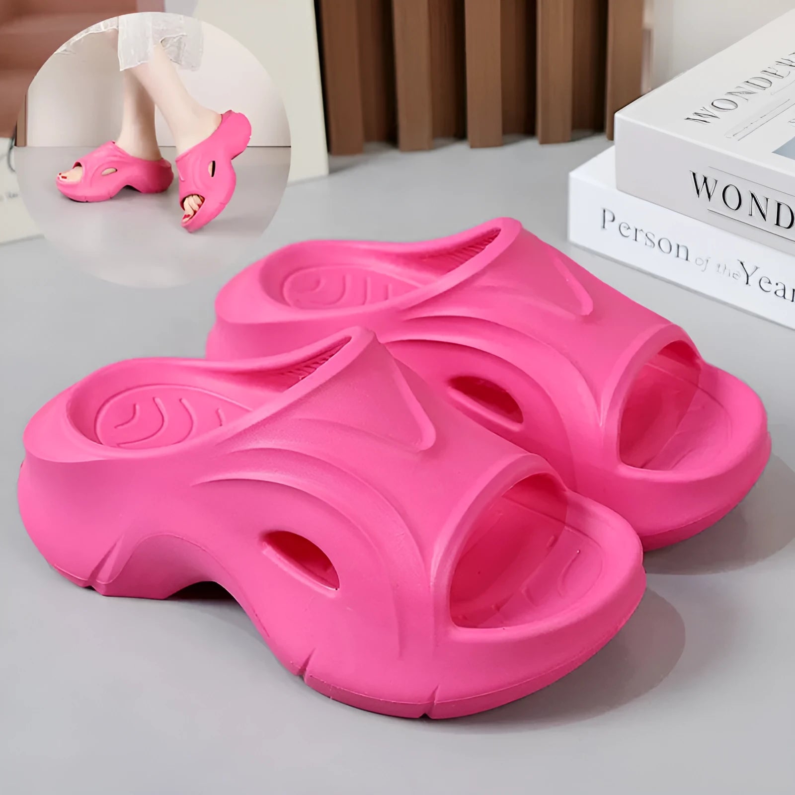Women's thick-soled EVA slippers in rose red, shown on a beach background.