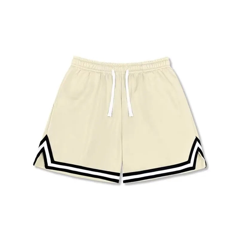 Man wearing loose grey sports shorts made from elastic polyester fabric.