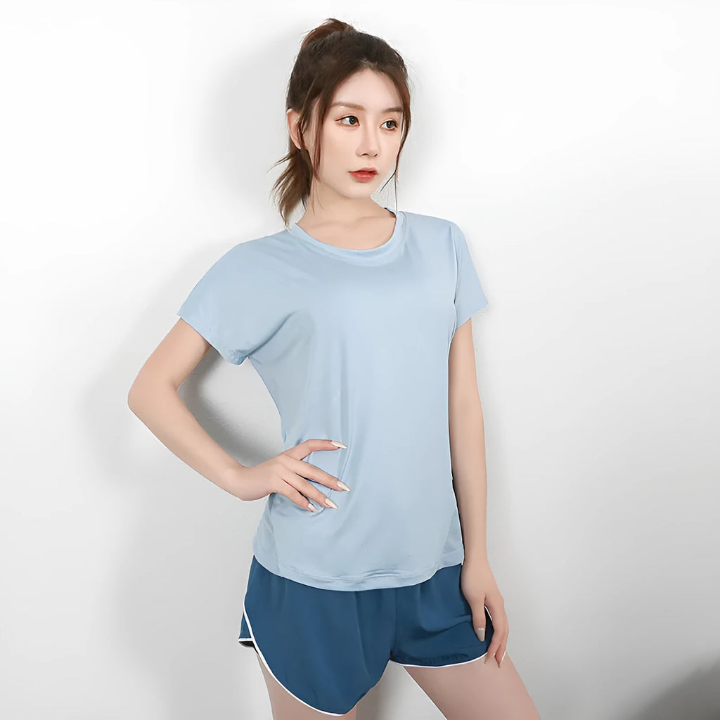 Women's short sleeve polyester sports t-shirt in pink, shown flat.