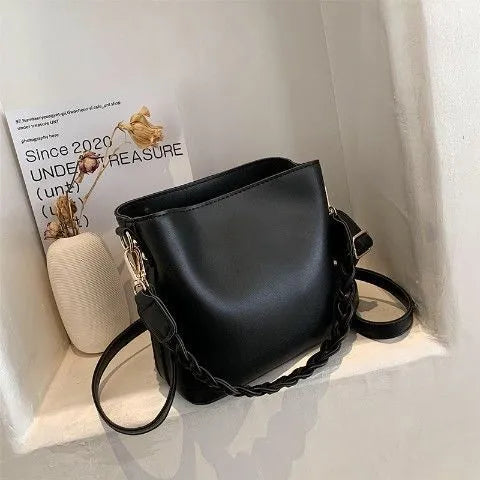 Retro woven PU leather crossbody bucket bag in khaki colour showing underarm design and textured surface