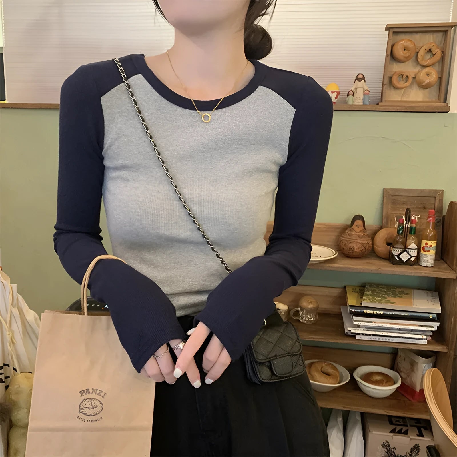 Women's dark blue viscose top with princess sleeves and embroidery detail on a hanger.