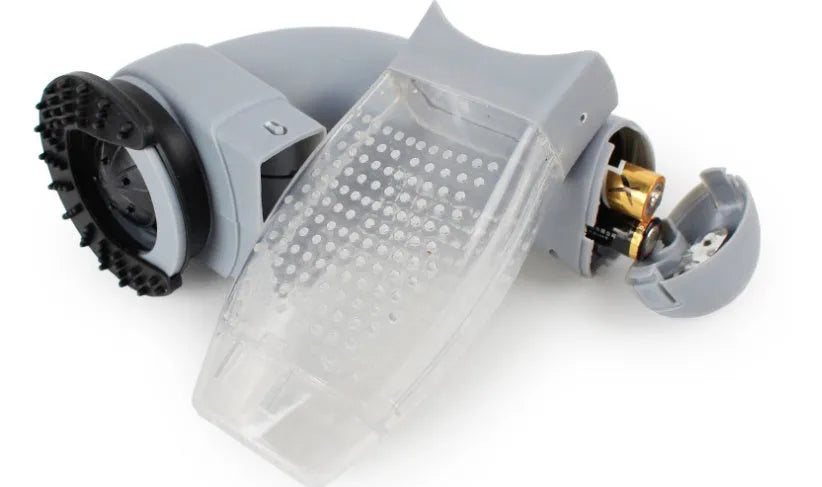 Grey portable electric pet hair removal brush with soft rubber head for grooming dogs and cleaning sofas.