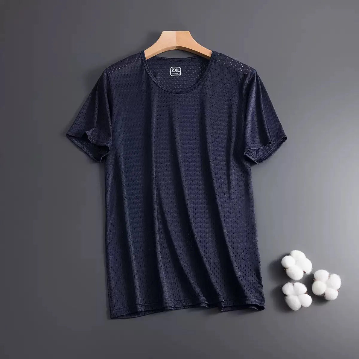 Man wearing a thin grey ice silk mesh short sleeve T-shirt with a crew neck.