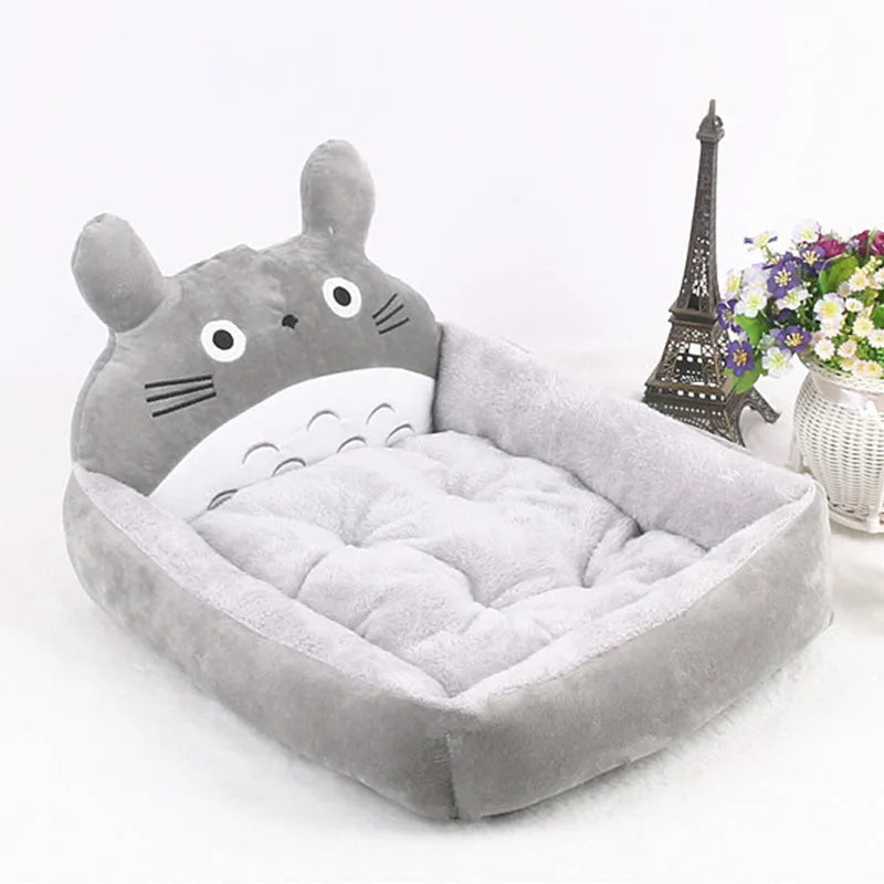 A cartoon-style washable pet sofa bed for small dogs and cats, shown in blue, brown, gray, or pink.