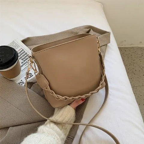 Retro woven PU leather crossbody bucket bag in khaki colour showing underarm design and textured surface