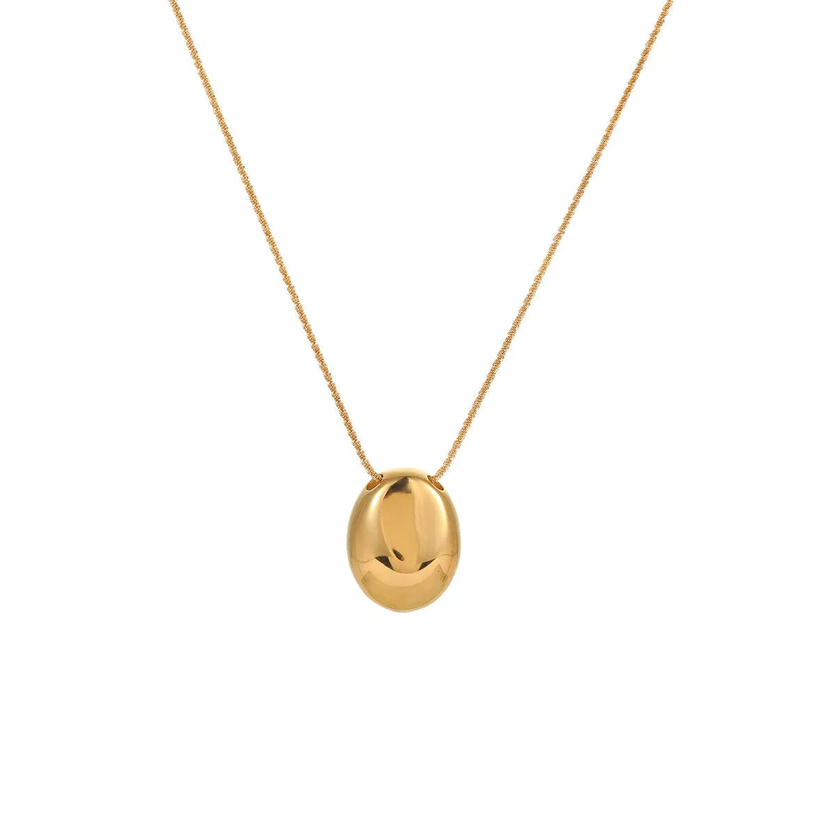 Gold geometric pendant necklace on a model, showing the adjustable chain length.