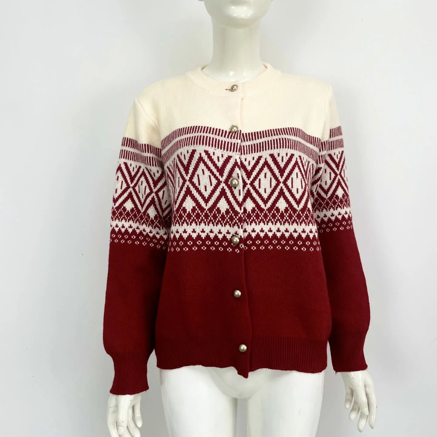 Red women's alpaca wool cardigan with grey diamond knit pattern and long sleeves.