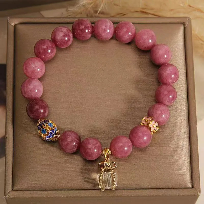 Natural stone bracelet with lotus tassel pendant and pearl details in pink lotus colour