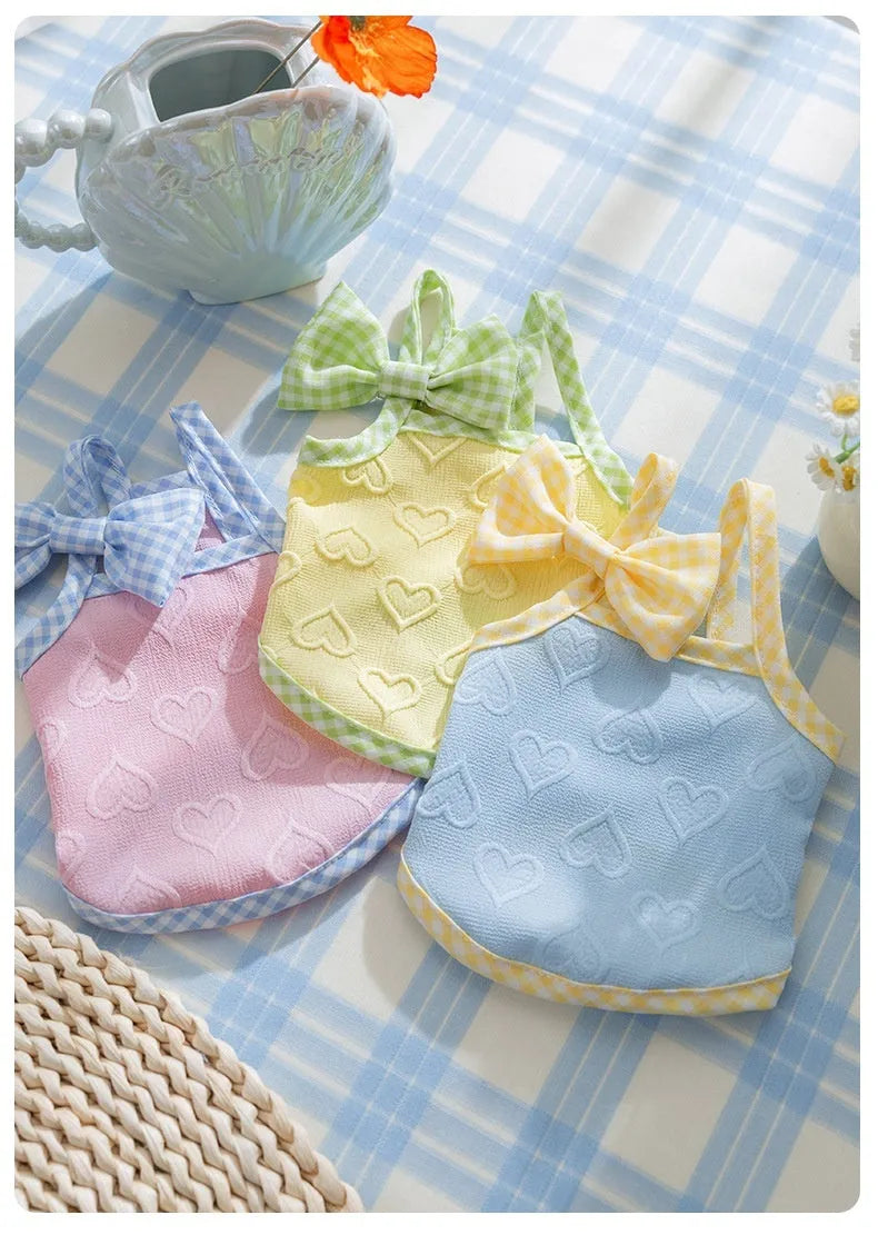 Small dog wearing heart relief texture bow suspenders vest in Bondi Blue colour