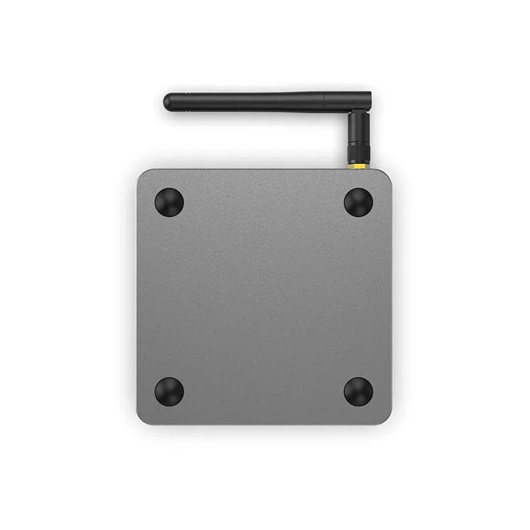 Android smart TV box set-top unit with remote control on a wooden table
