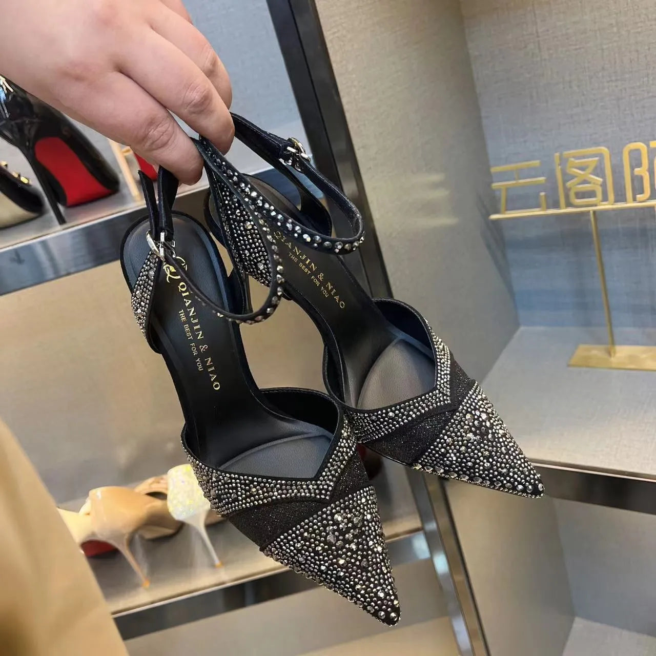 Women's black hollow high heels with red sole, stiletto heel and pointed toe design