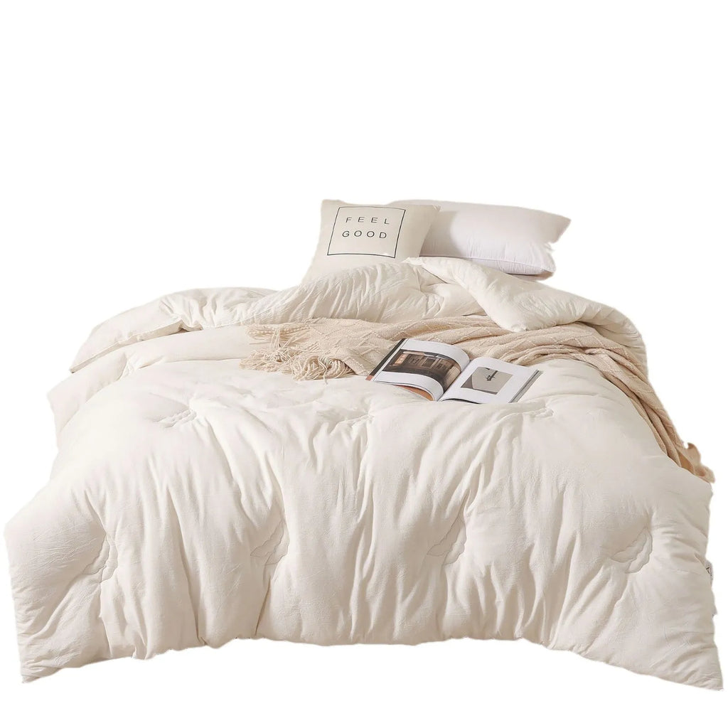 A pure cotton soybean fibre airable quilt in grey, shown with a zipper detail, on a bed.
