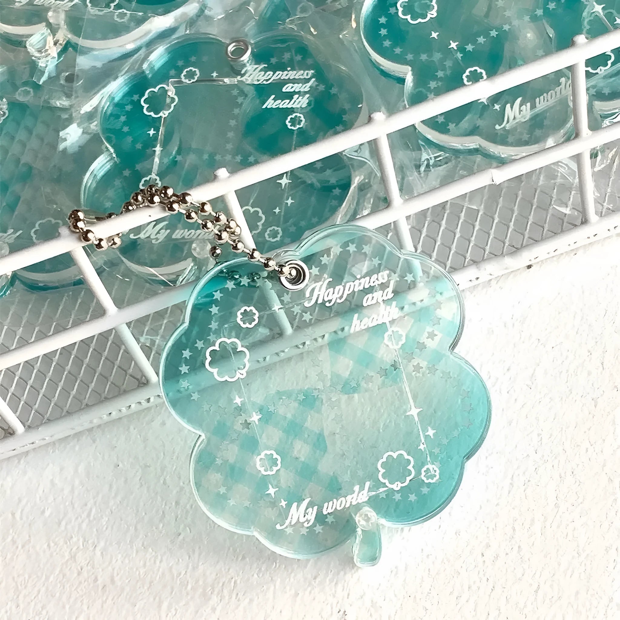 Acrylic four-leaf clover pendant keychain in elegant blue, grass green, or mint green.