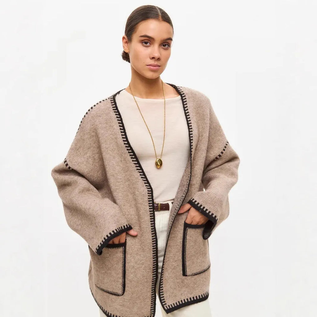 Lace-up front knitted cardigan in camel colour showing loose mid-length design and long sleeves