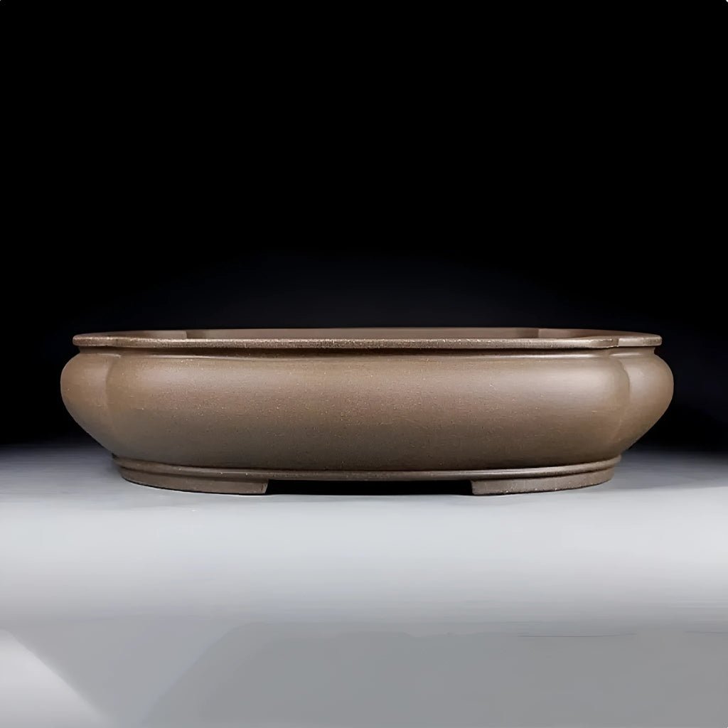 Handmade antique purple clay papaya-shaped flower pot on a wooden surface.