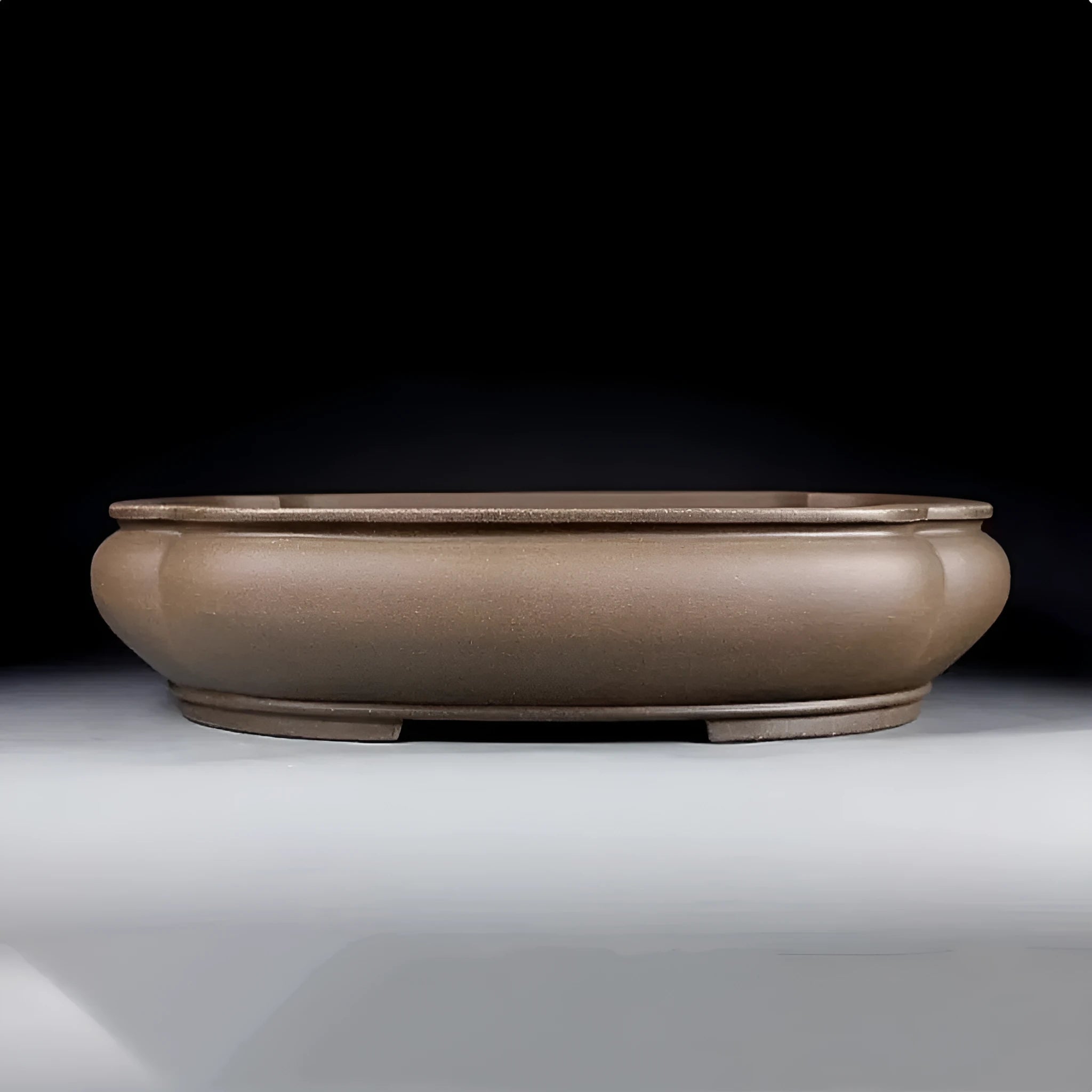 Handmade antique purple clay papaya-shaped flower pot on a wooden surface.