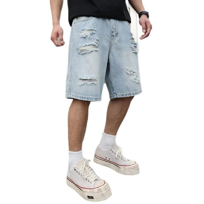 Light blue ripped denim shorts with a loose straight-leg fit on a mannequin.