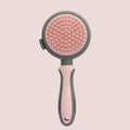 Green two-sided silicone pet brush with retractable slicker on one side and octopus-teethed massager on the other