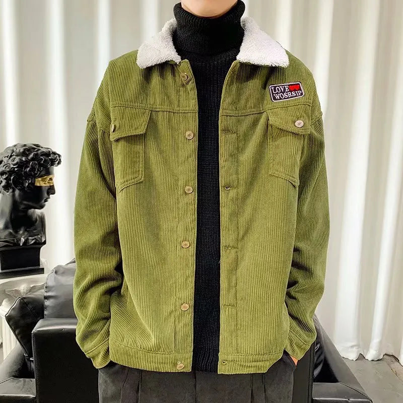 Man wearing a khaki loose-fit corduroy workwear jacket with side pockets.