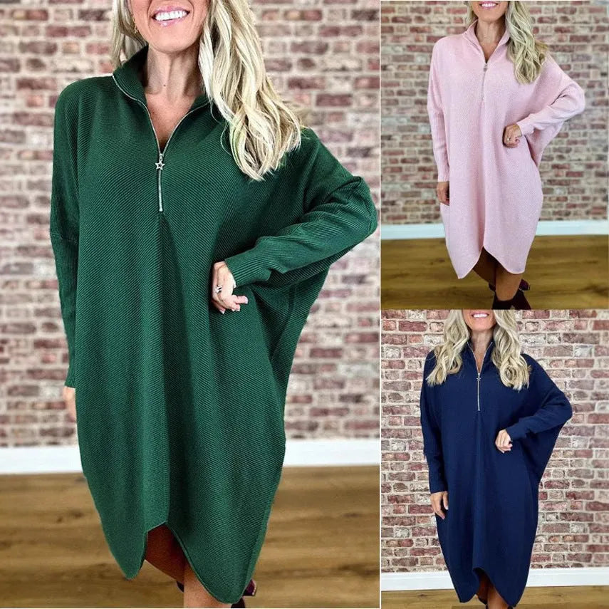 Women's solid colour loose knitted dress with raglan sleeves, shown in dark green.