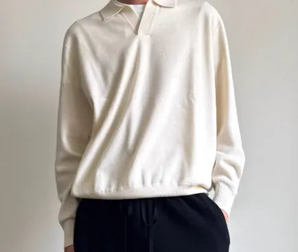 Men's loose-fit lapel-collar wool sweater in navy blue, laid flat showing front design.