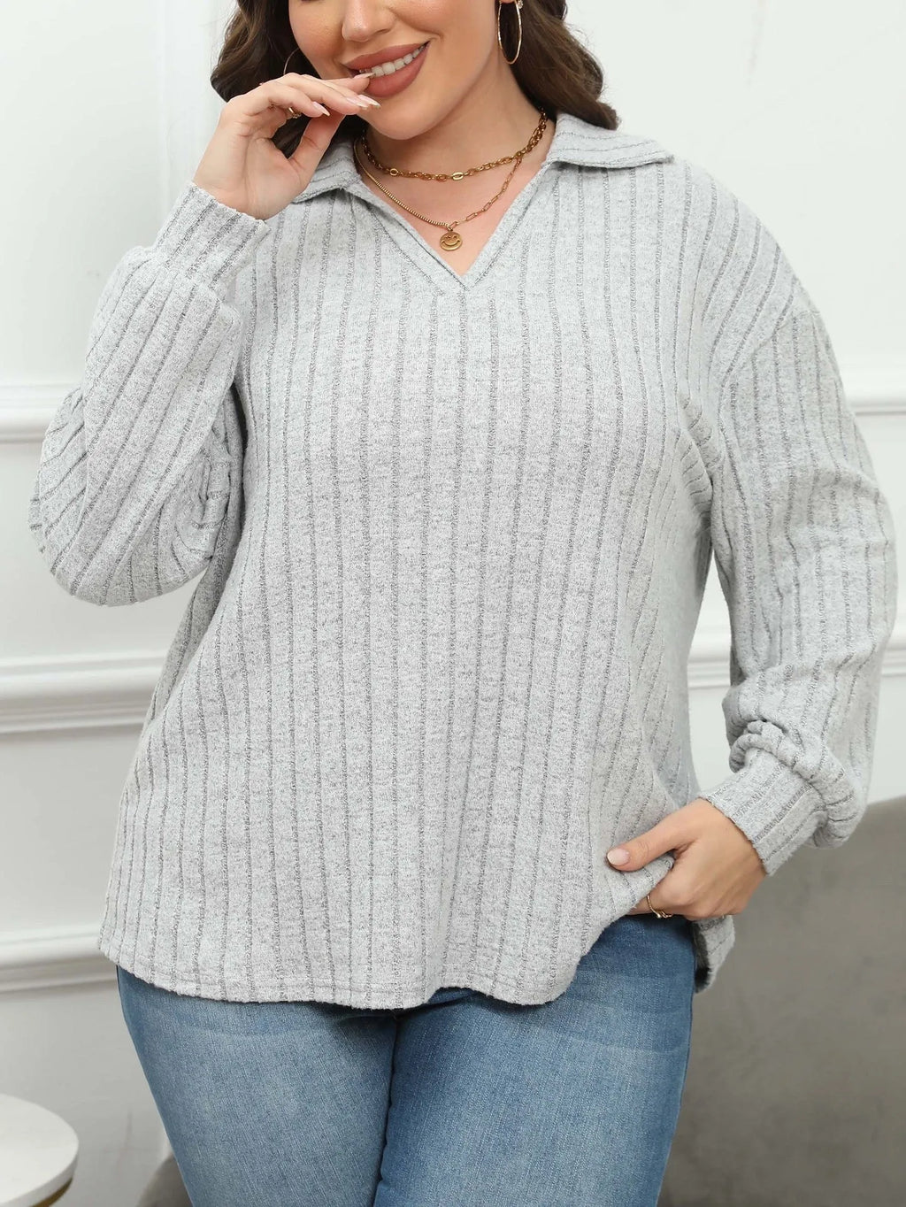 Women's plus size gray polo collar fleece shirt with lantern sleeves on a hanger.