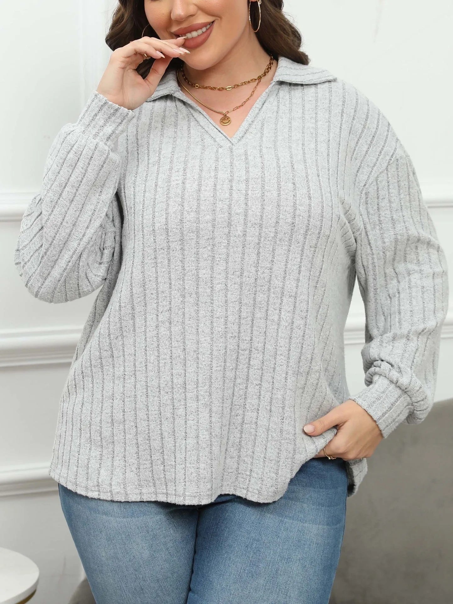 Women's plus size gray polo collar fleece shirt with lantern sleeves on a hanger.