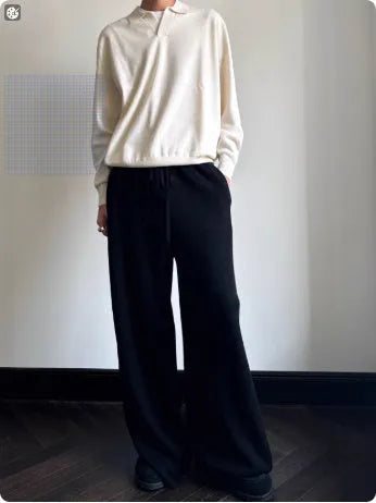 Men's loose-fit lapel-collar wool sweater in navy blue, laid flat showing front design.