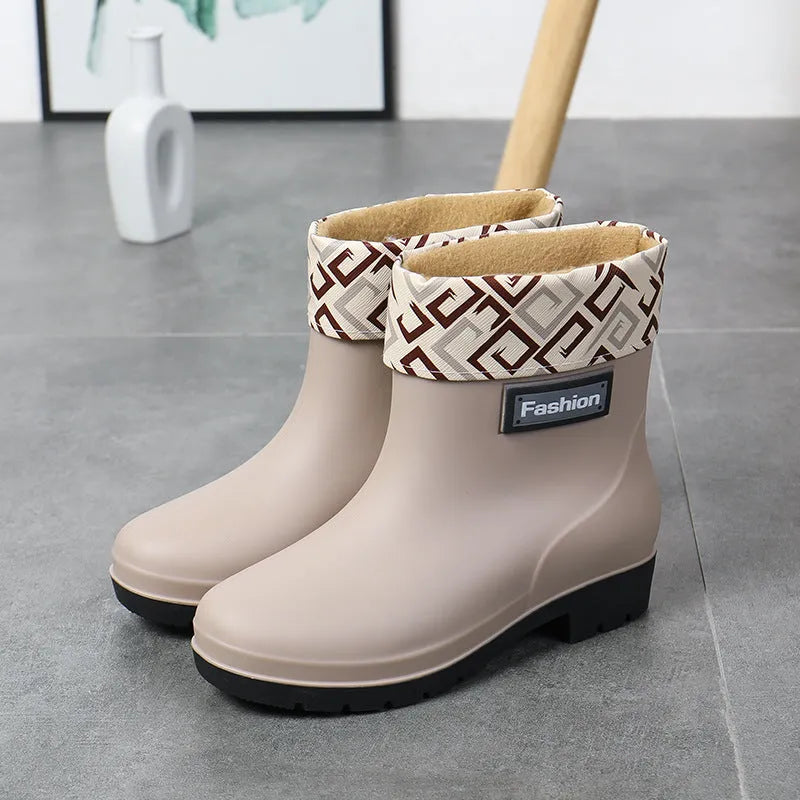 Women's mid-calf PVC rain boot in black, shown with a low heel and optional wool lining.