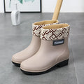 Women's mid-calf PVC rain boot in black, shown with a low heel and optional wool lining.