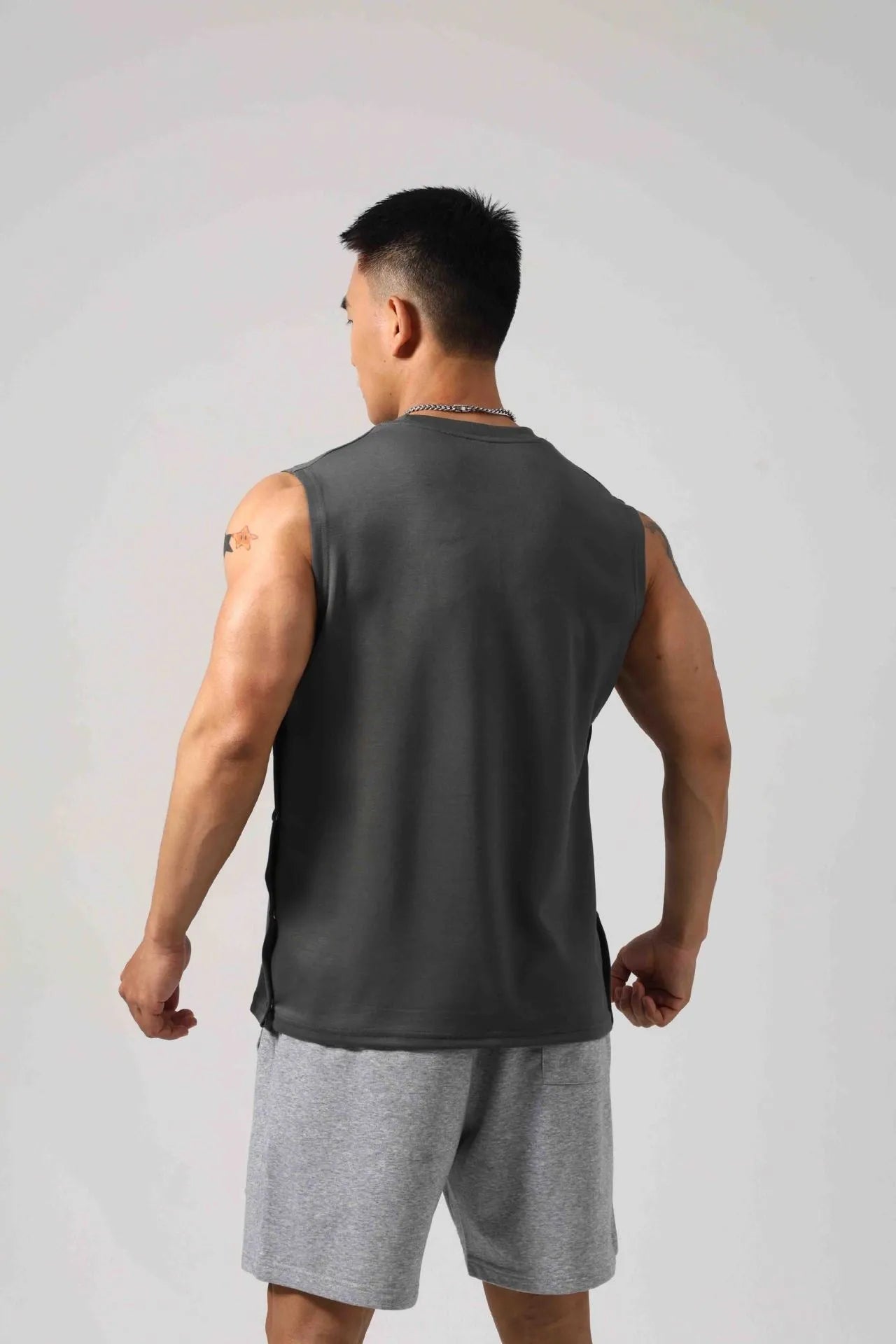 Korean style loose cotton fitness vest for men with hidden hook side openings.