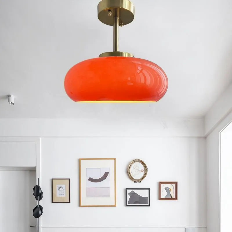 Three-headed Bauhaus pendant light with milky white glass egg tart shades hanging from a ceiling.