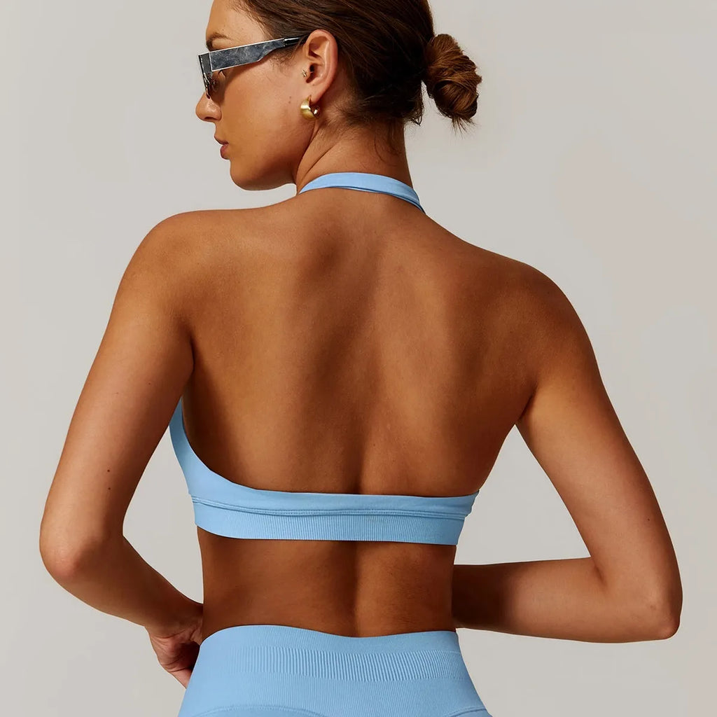 Women's black halter neck nylon sports bra for yoga and workouts on a mannequin.