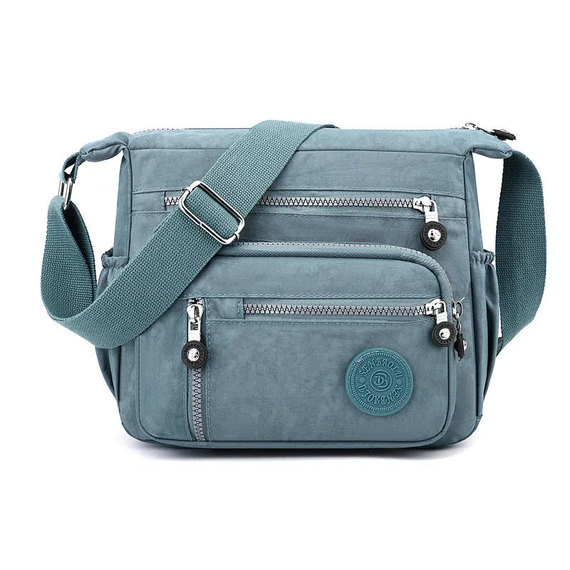 Soft nylon messenger bag with single shoulder strap in square vertical design showing grey colour option