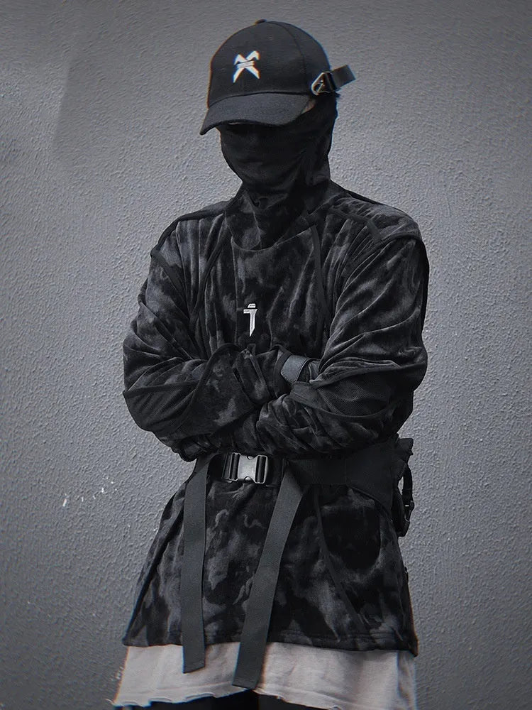 Man wearing a black and grey tie dye printed finger turtleneck sweater with drop shoulder sleeves.