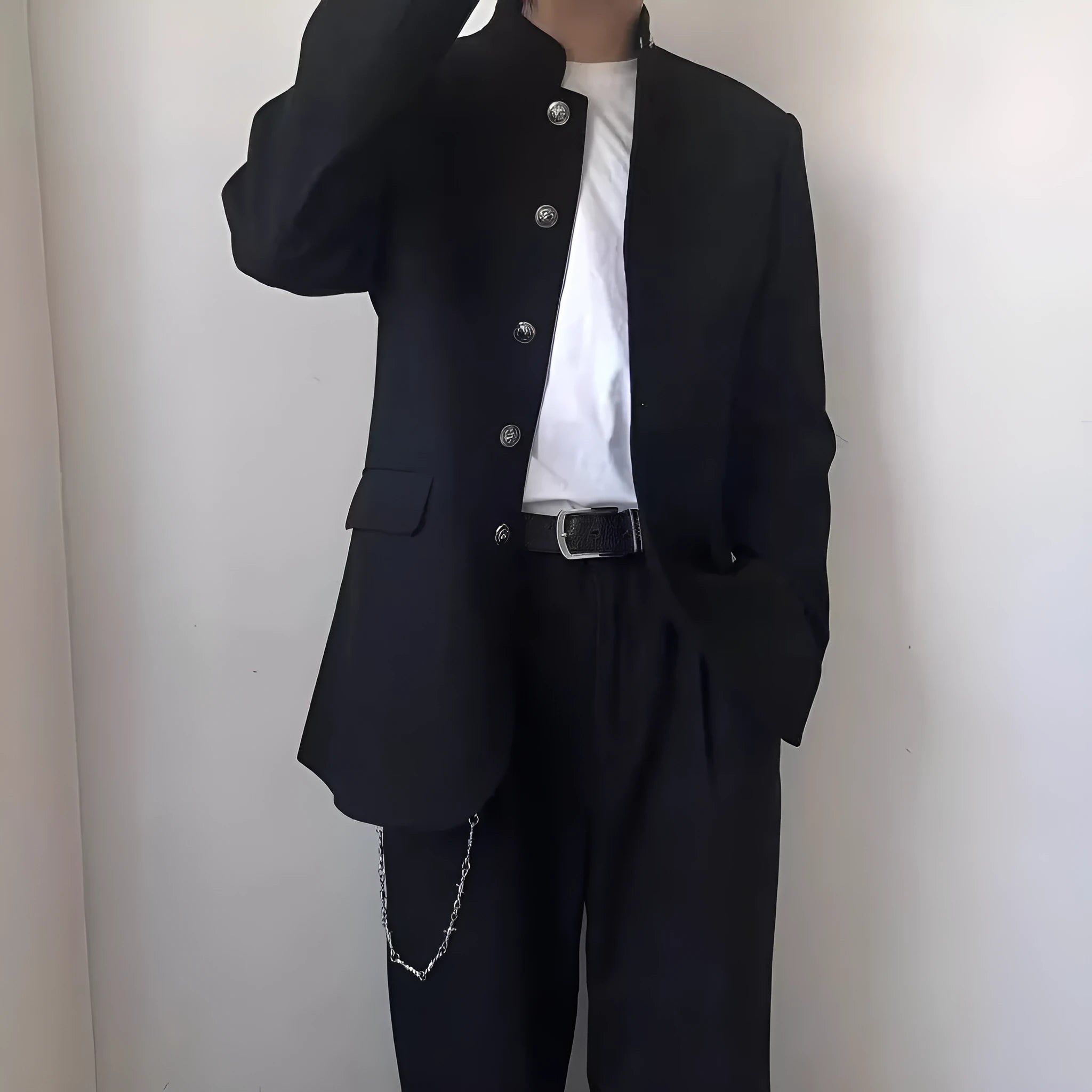 Solid black Korean style casual suit blazer with long sleeves, loose fit, and patch pockets on model