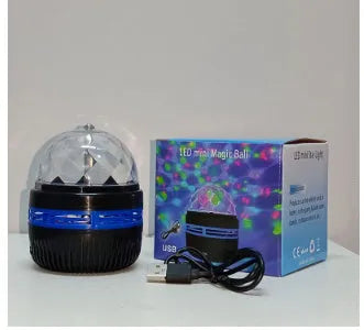 Compact USB-powered LED lamp projecting rotating colourful stars and galaxies onto a dark wall.