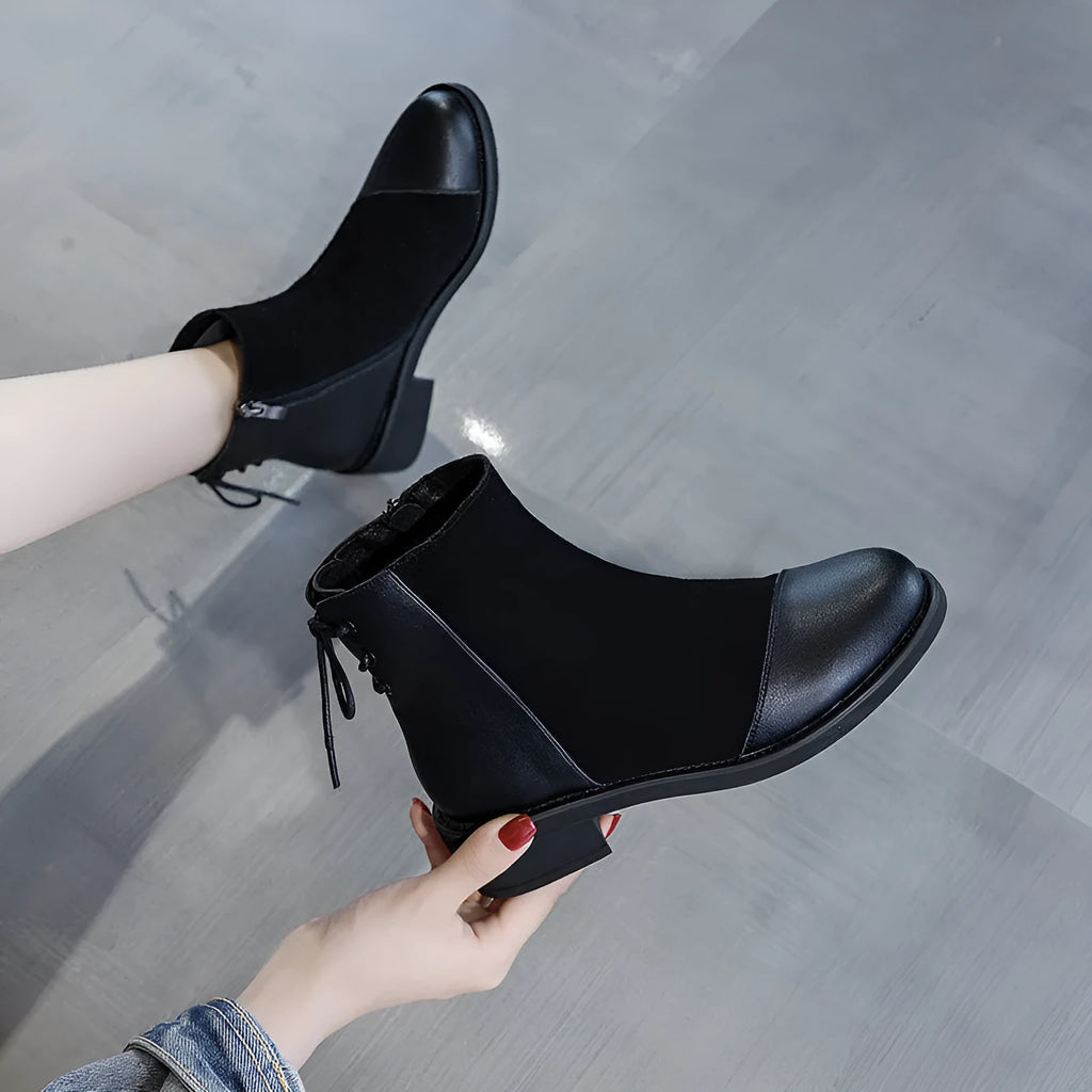 Women's black knee-high Martin boots with side zip, round toe, bow detail, and non-slip rubber sole