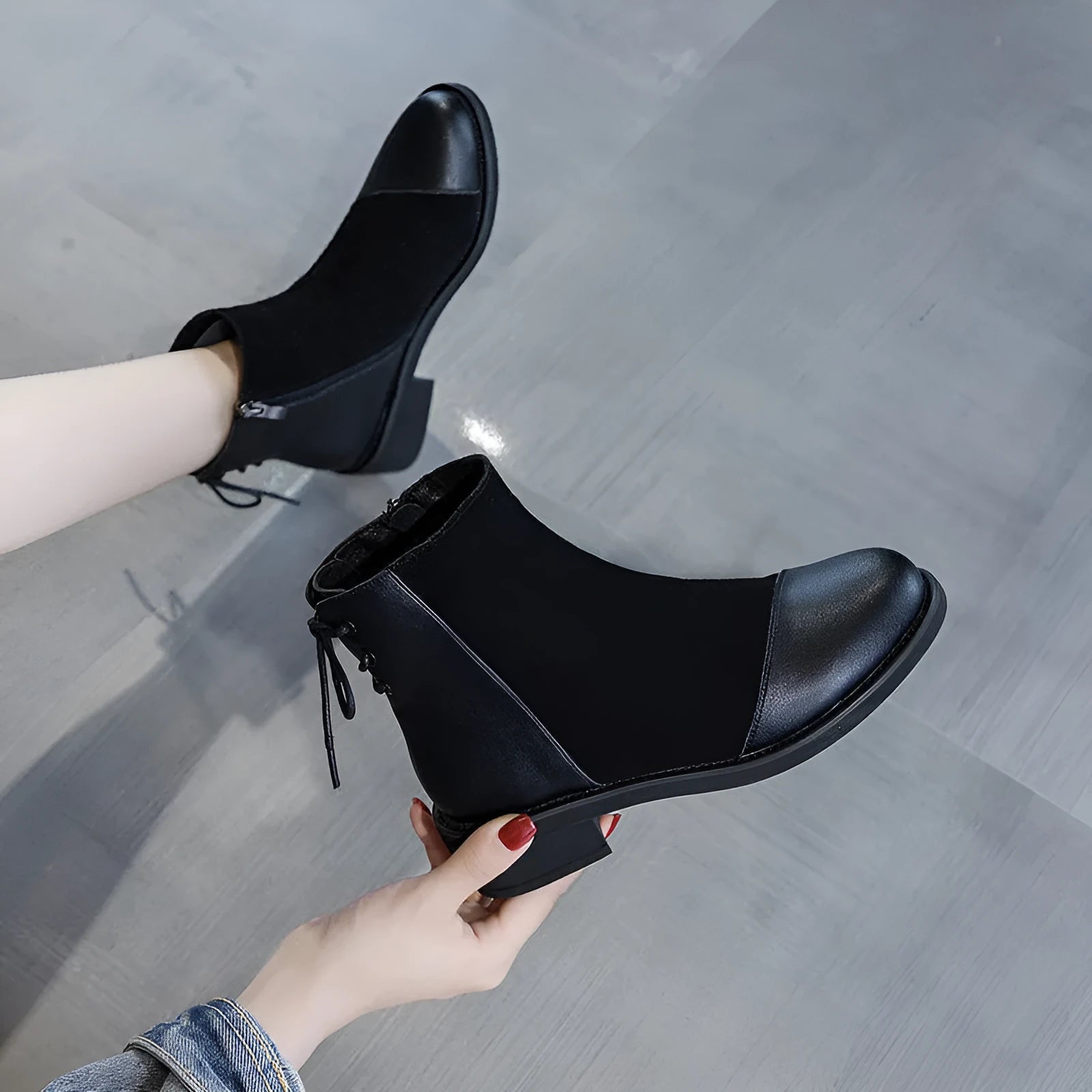 Women's black knee-high Martin boots with side zip, round toe, bow detail, and non-slip rubber sole
