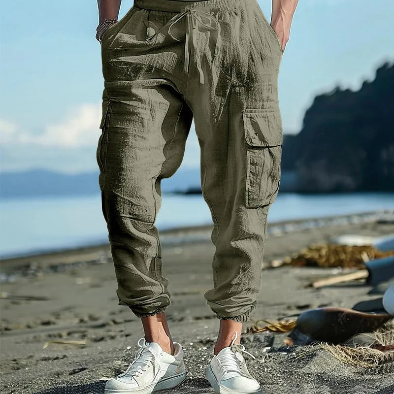Men's solid colour linen casual trousers with ankle-tied cuffs, multiple pockets, and a drawstring waist