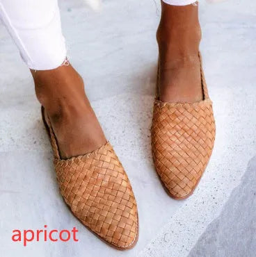 A pair of flat buckle sandals with a pointed toe, shown in one of the available colours.