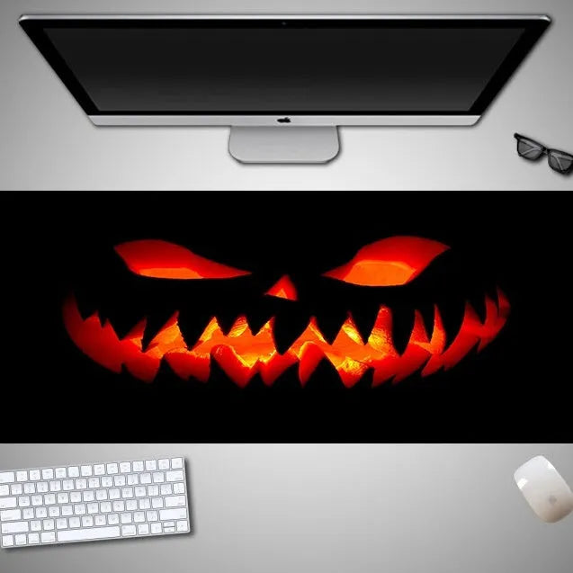 Large Halloween-themed computer mouse pad with graphic design on a desk