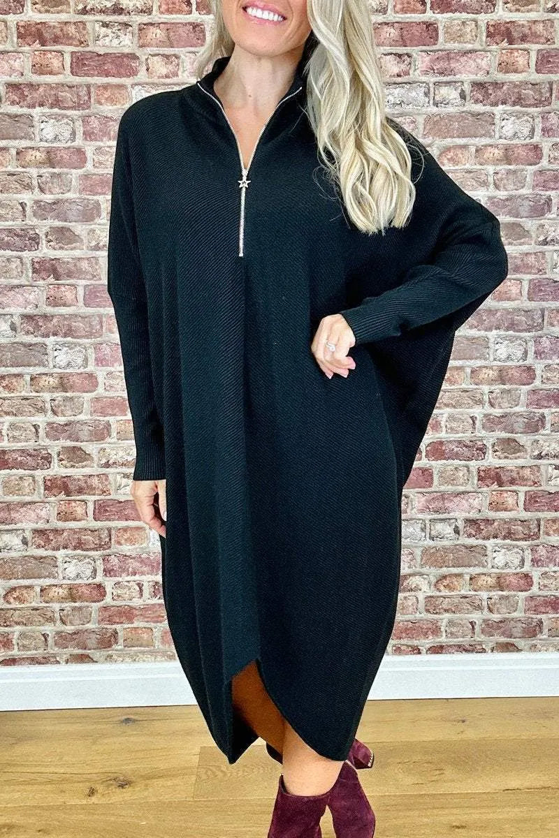 Women's solid colour loose knitted dress with raglan sleeves, shown in dark green.