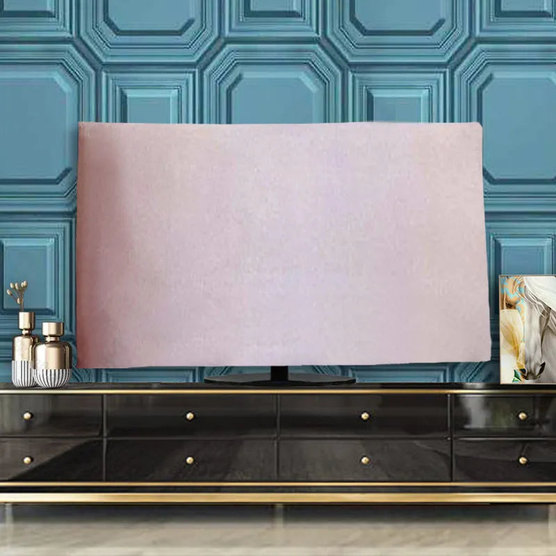 A pink velvet television cover draped over a flat-screen TV, showing its elasticated hem and soft fabric texture.