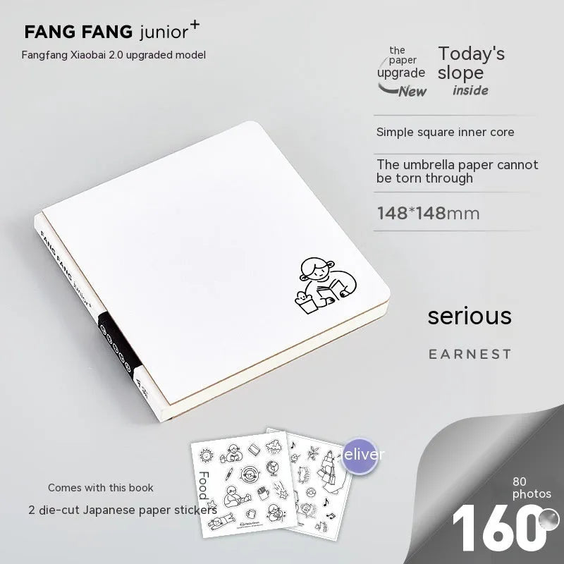 Small white square notebook with checkered pages and decorative sticker sheets