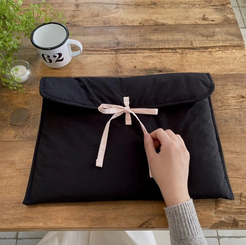 Women's black quilted laptop bag with ballet bow and striped pattern