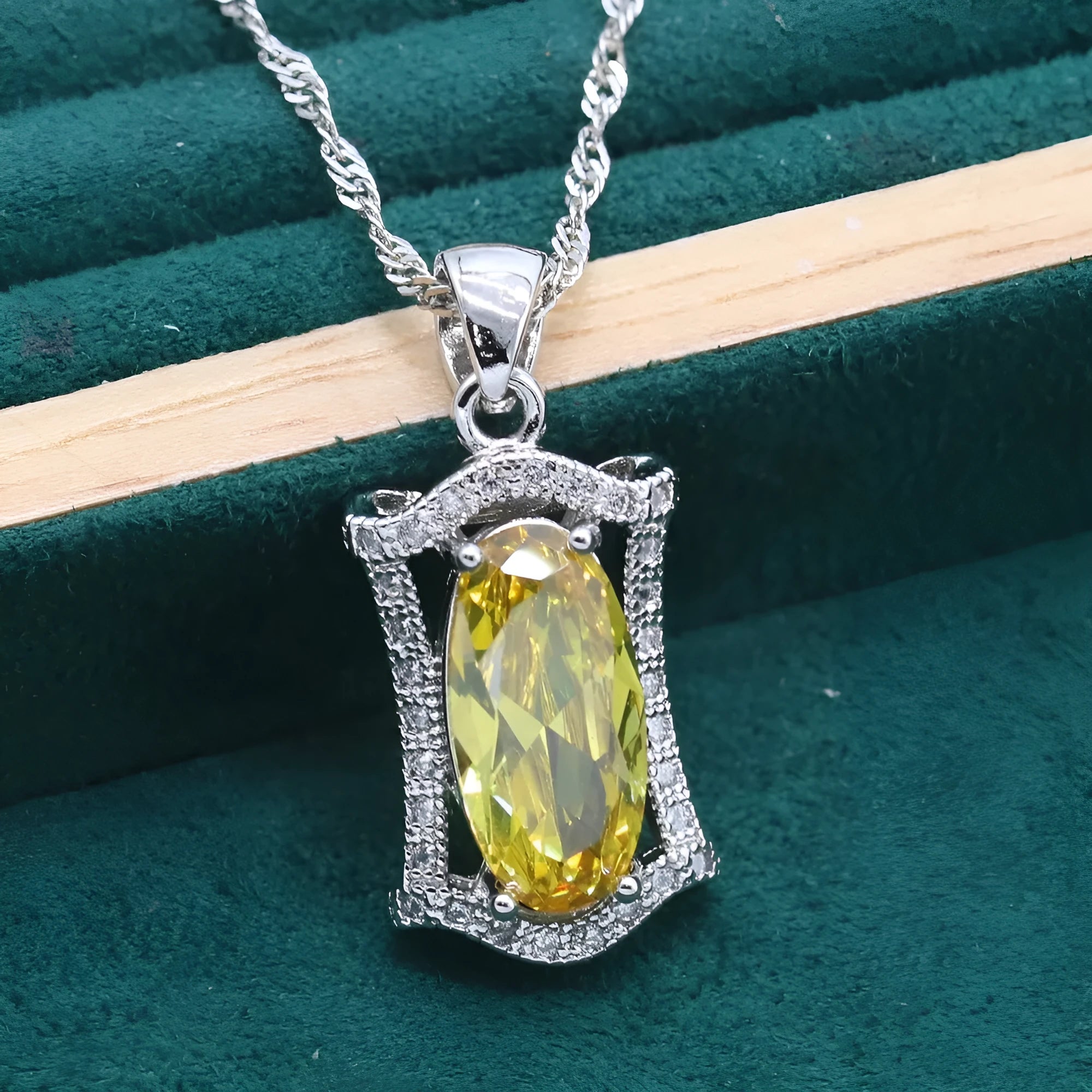 Yellow and olive anti-allergy alloy zircon jewellery set showing necklace, earrings, ring, and bracelet on a dark background.
