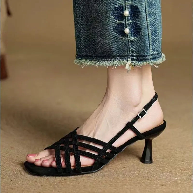 Women's light brown retro high heel sandals with thin cross straps and an ankle buckle on a square toe.